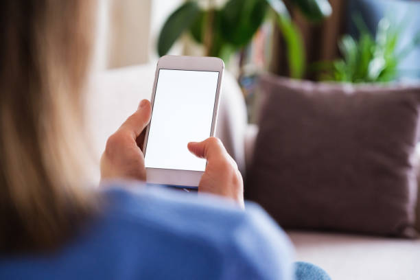 istock Woman using mobile phone at home and lying down at sofa 1371238617