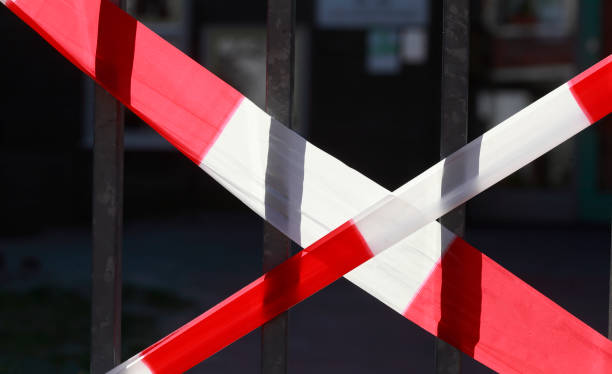 Red and white barrier tape, on a fence, closed due to coronavirus, Germany, Europe stock photo