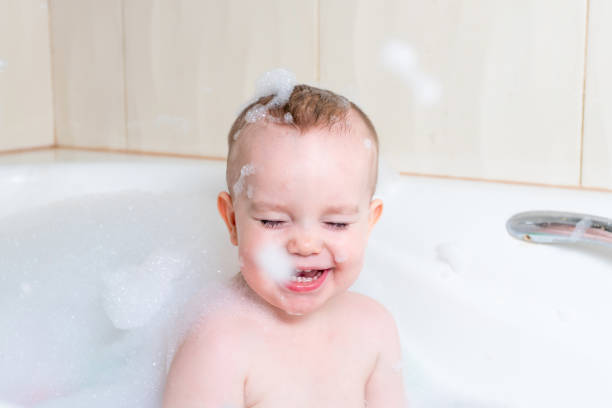 istock Cheerful baby in a bath with soap sud 1371239991