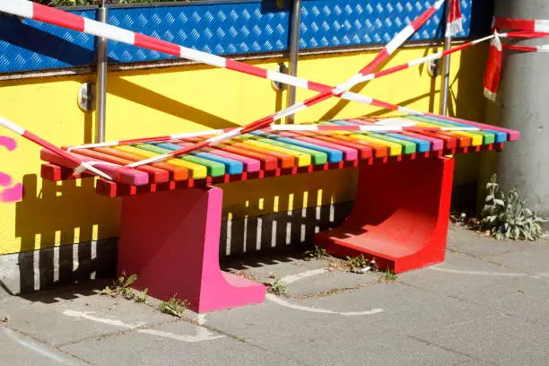Barrier tape, Colorful bench of an ice cream parlour closed due to coronavirus, Germany, Europe