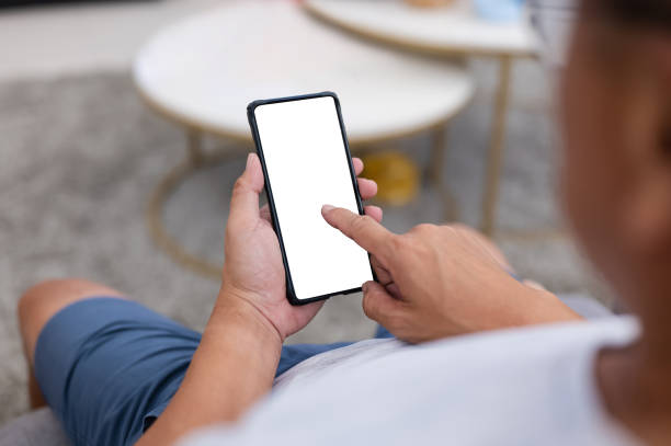 istock Adult man using smart phone with blank white screen at home 1371243188