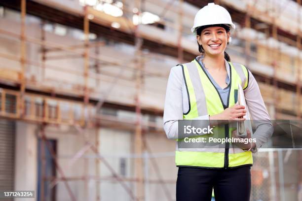 Shot Of A Young Woman Working On A Construction Site Stock Photo - Download Image Now
