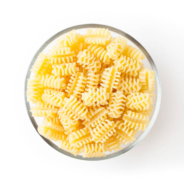 istock Uncooked radiatori pasta in glass bowl isolated on white background with clipping path 1371245512