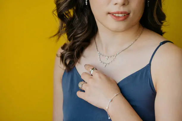 Photo of Portrait of beautiful Asian woman dressed in a posh jewelry set of diamond ring, necklace, bracelet and earrings