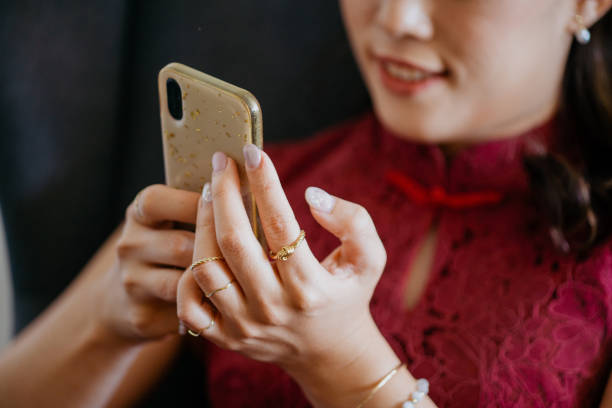 Beautiful Asian business woman using smartphone while working at office