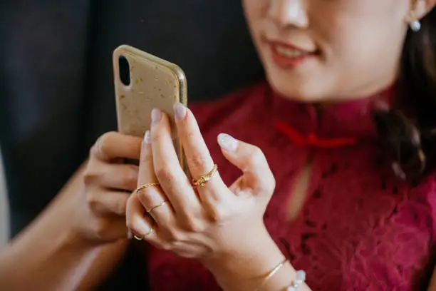 Photo of Beautiful Asian business woman using smartphone while working at office