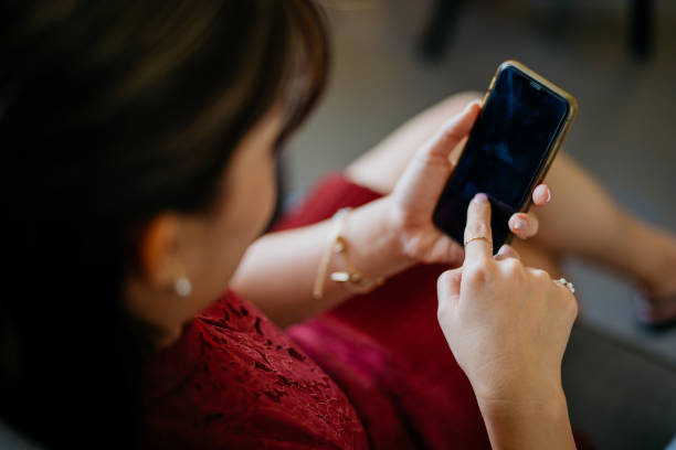 istock Beautiful Asian business woman using smartphone while working at office 1371246737