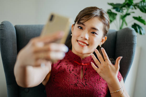 istock Beautiful Asian business woman using smartphone while working at office 1371246756