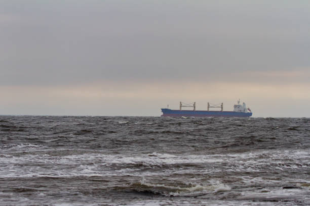 istock Cargo vessel on the horizon with rough stormy sea 1371247847