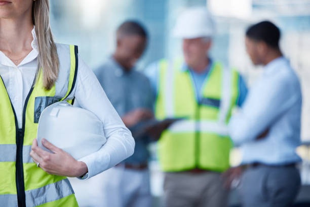 istock Shot of a female builder holding a hard hat 1371247989