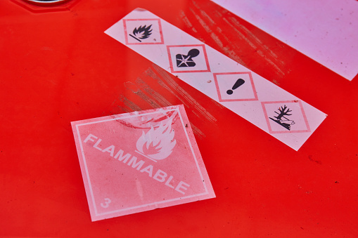 Flammable sign on red chemical tank