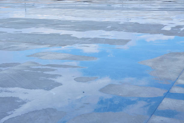 Reflection of cloud sky on water cement floor