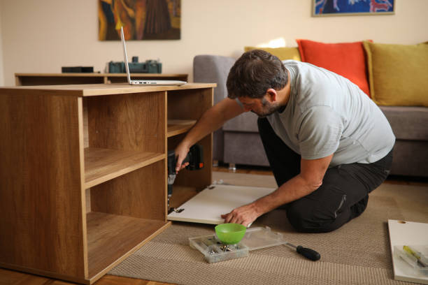 istock Father and son assembling bookshelves at their home 1371249635