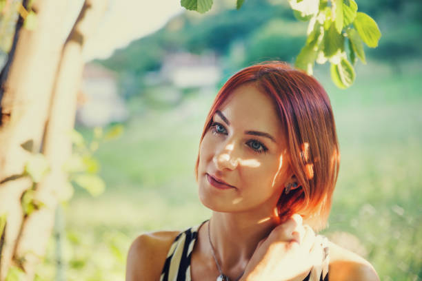 Redhead young woman portrait smiling in Summer