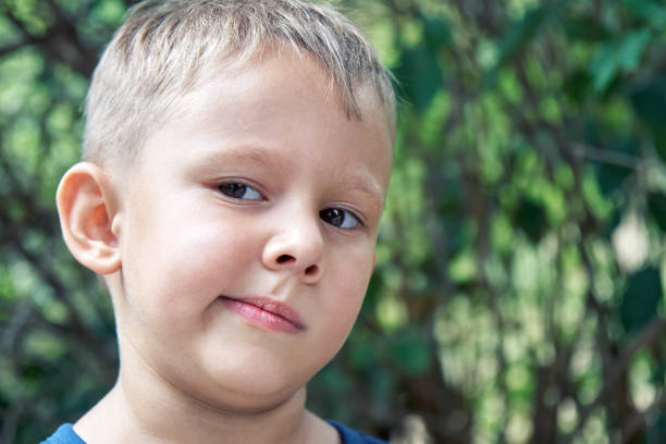 istock Preschooler boy grimaces making weird face expressions 1371256213