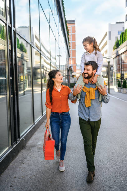 Young cheerful family in shopping.