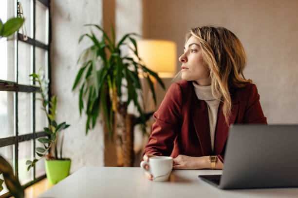 istock Businesswoman, working online, looking through the window. 1371258476