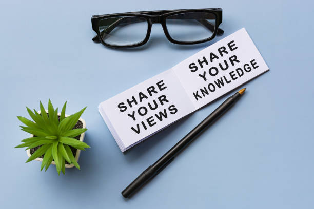 Motivational text on notepad with reading glasses and potted plant stock photo