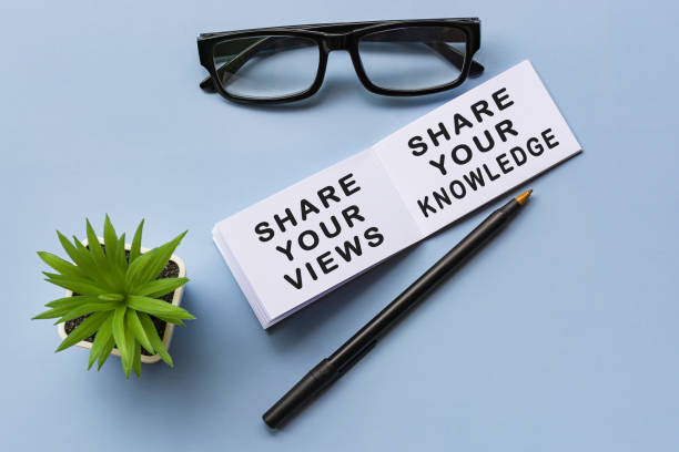 Motivational text on notepad with reading glasses and potted plant Motivational text on notepad with reading glasses and potted plant - Share your views, share you knowledge. constructive feedback stock pictures, royalty-free photos & images