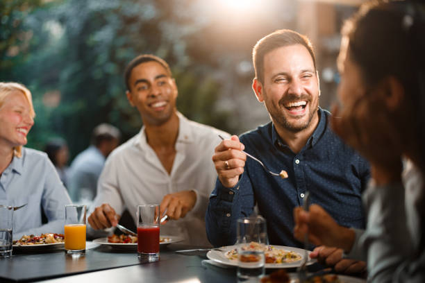 istock Group of happy entrepreneurs talking while enjoying in lunch at a restaurant. 1371260201