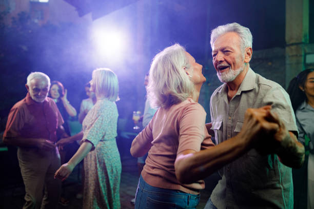 Happy mature couple dancing in a disco.