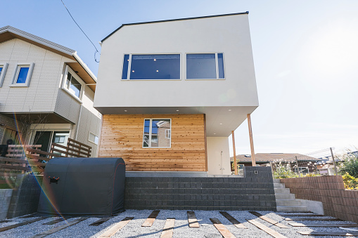 A modern barn house with a mezzanine, large windows, and a lovely terrace with a garden  - 3d render