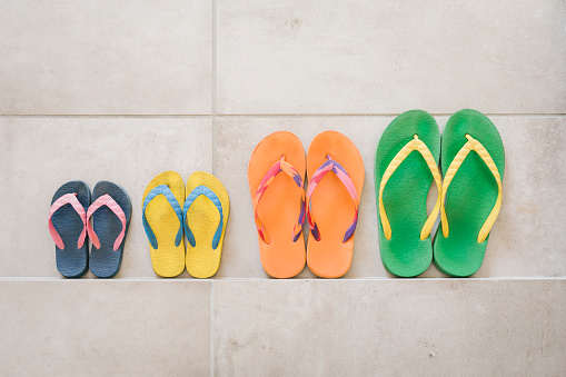 Color flip flops by the swimming pool in sunny day