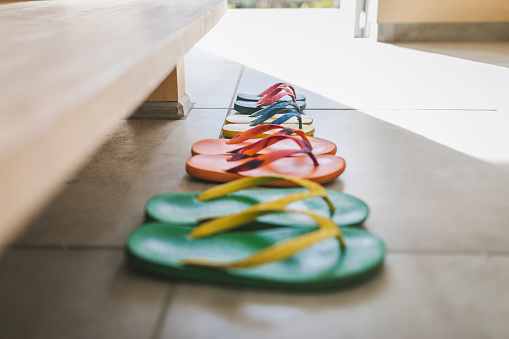 Flip-flops of family in the entrance space of modern Japanese house.