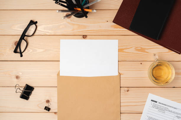 istock Letters and Office Supplies on Table Desk. Top View 1371261794