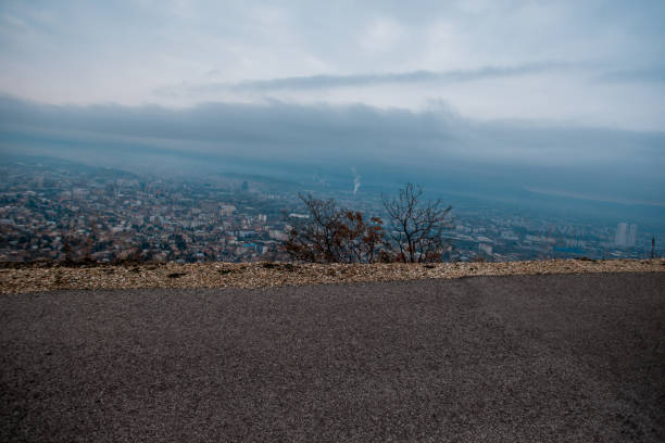 Panorama shot from a high road looking over a city covered in fog