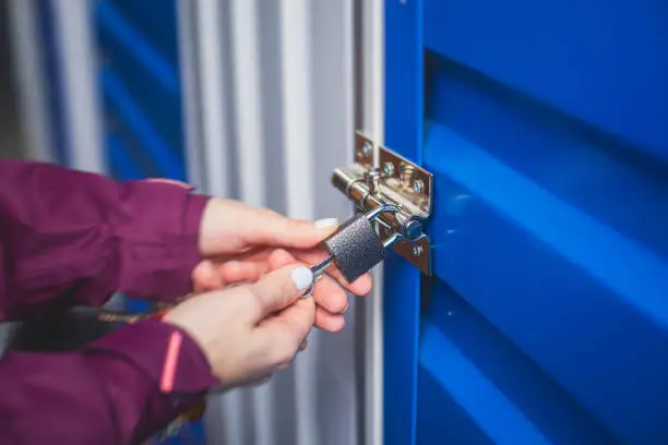 Photo of View of self storage warehouse, process of keeping and storing the goods and items in storage units, self-storage building, lock and key concept