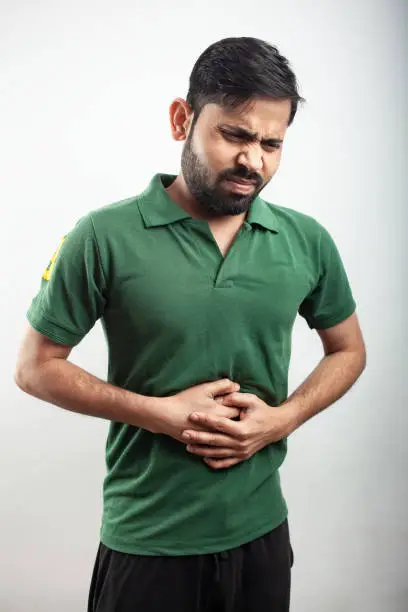 Photo of man with upset stomach pain due to acidity