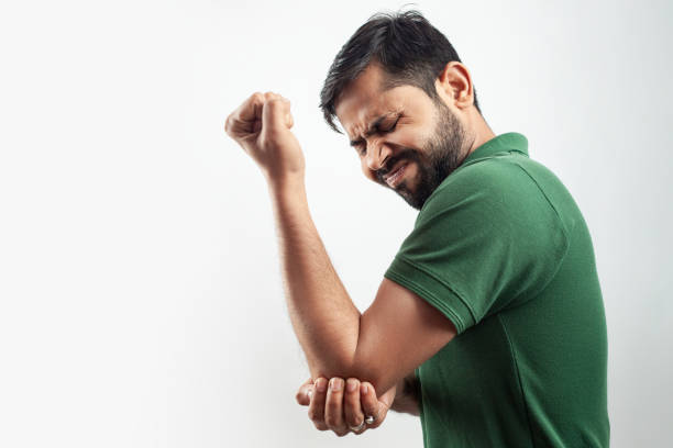 istock single person showing elbow injury pain concept with grimace expression 1371266041