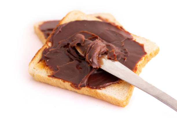 istock mouth watering Choco spread on roasted bread with steel spoon 1371266219