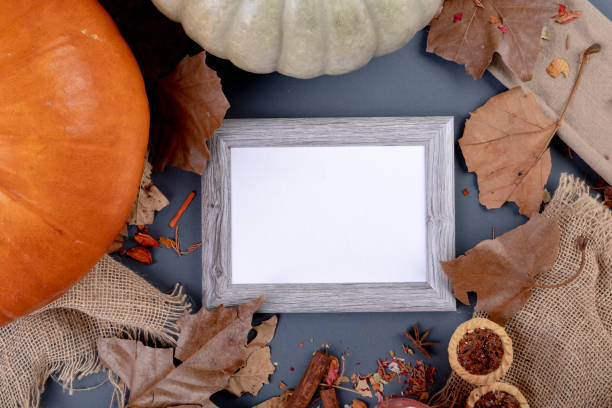 istock Composition of halloween decoration with pumpkin and frame with copy space on grey background 1371271173