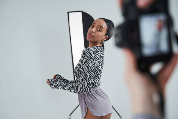 istock Multiracial dancer looking at the camera while posing to the female photographer 1371273746