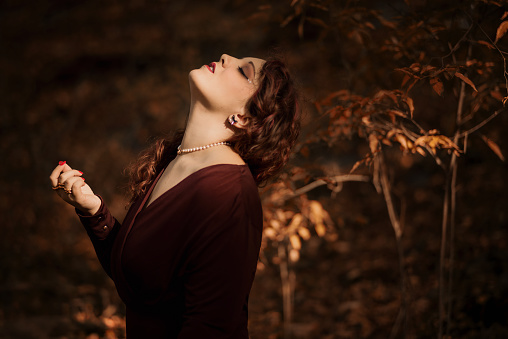 Beautiful and elegant young woman portrait showing her neck with her eyes closed