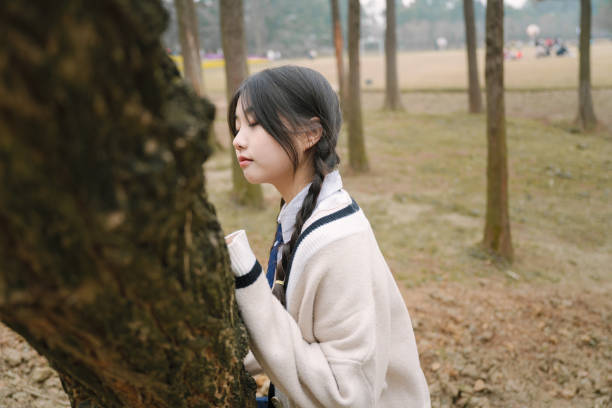 istock Beautiful asian girl under the tree 1371280304
