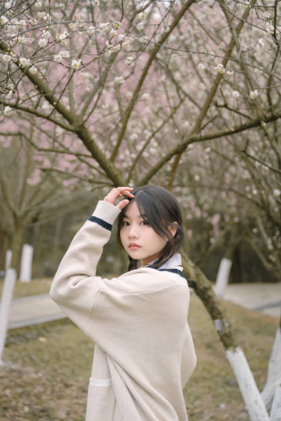 istock Asian beautiful girl under cherry tree 1371280790