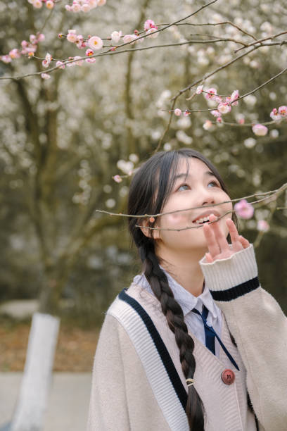 istock Asian beautiful girl under cherry tree 1371280801