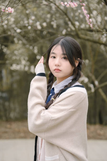 istock Asian beautiful girl under cherry tree 1371280893