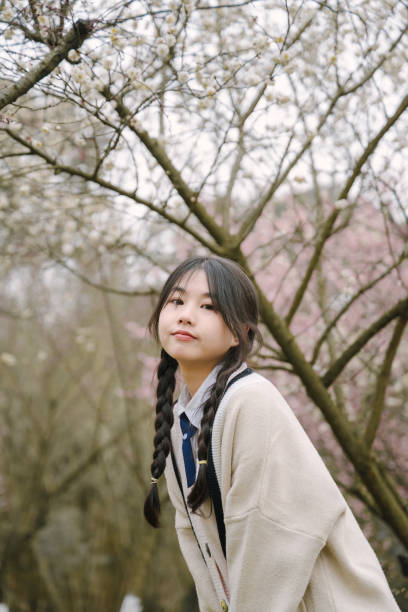 istock Asian beautiful girl under cherry tree 1371281193