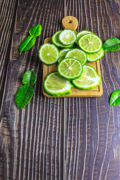 istock Fresh bergamot fruit slices on wooden 1371282587