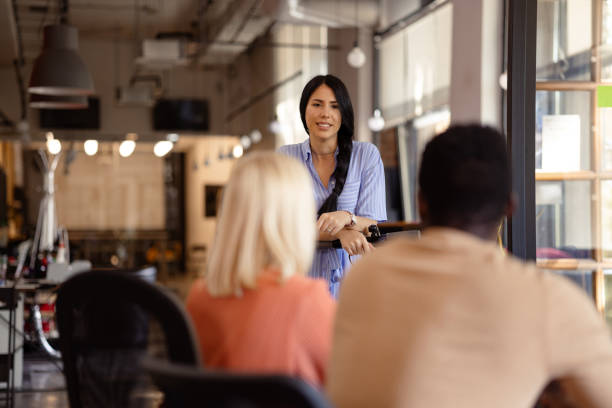 istock Diverse group of white collar workers assembling in their office for a meeting 1371284321