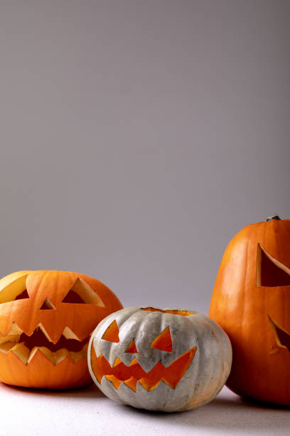 istock Composition of halloween jack o lanterns and copy space on grey background 1371285228