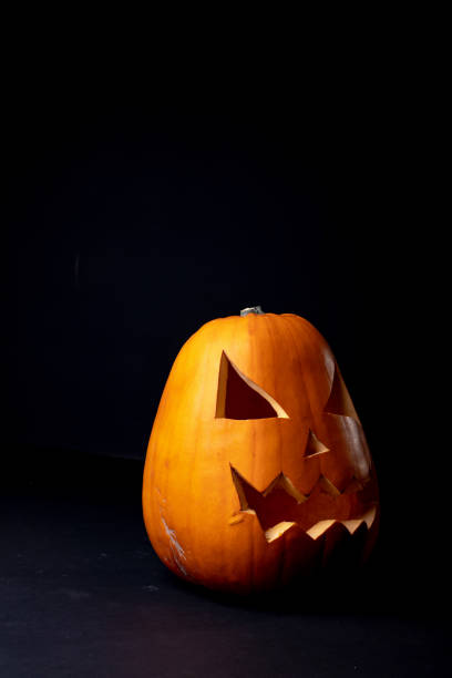 istock Composition of halloween jack o lantern and copy space on black background 1371285561