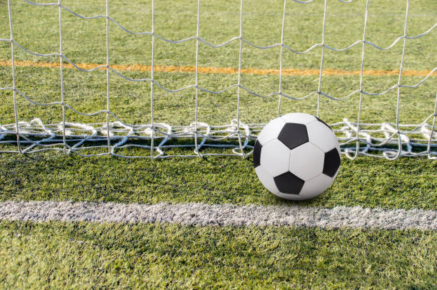 istock soccer ball in the goal 1371285710