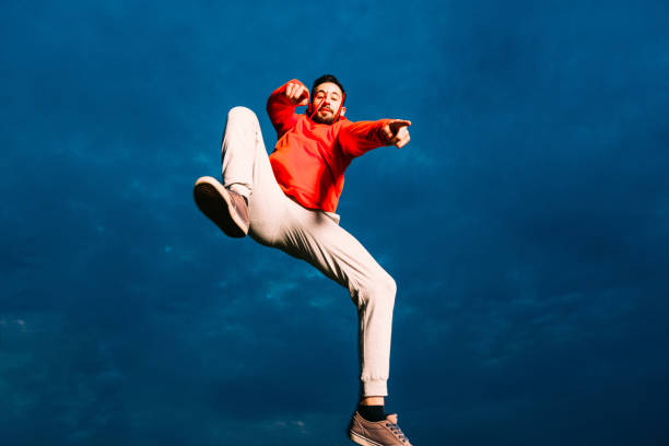 istock Young Caucasian man performs parkour jumping 1371286094
