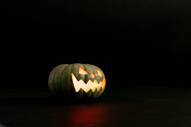 Composition of halloween jack o lantern and copy space on black background. horror, fright, halloween tradition and celebration concept digitally generated image.