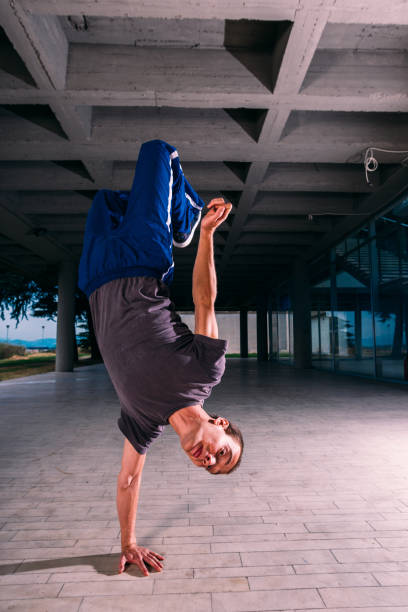 istock Young man exercising handstand at urban place 1371286785